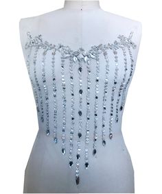 a white dress with lots of beads on it