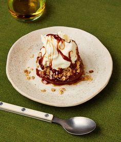 a dessert on a white plate with chocolate sauce and whipped cream