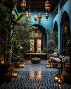 an indoor courtyard with candles and potted plants