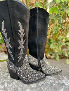 Add Glamour to any party with these "Addie" Black Rhinestone Boots with ankle silver rhinestone detailing and side flared out feathered detailing. These boots have a Pointed Toe Silhouette, side zipper closure, 3" wooden block heel, 14" calf length from ankle to top of bootie. 17" total inches tall from sole to top of Bootie. These boots are made of a soft suede like material. Western Rhinestone Boots With Round Toe, Black Sparkle Cowboy Boots, Western Pointed Toe Boots With Rhinestone Rivets, Black Rhinestone Mid Calf Boots, Black Western Boots With Rhinestone Rivets, Rodeo Boots, Western Style Boots, Western Boutique, Rodeo Outfits