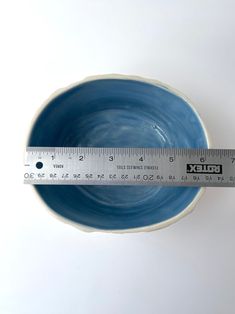 a blue bowl with a measuring tape around it