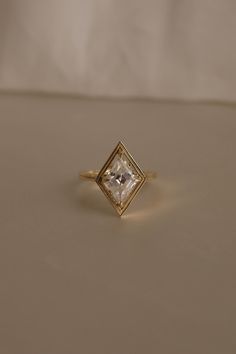 a diamond ring sitting on top of a table