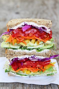 a sandwich with lettuce, tomato, and cucumber on rye bread