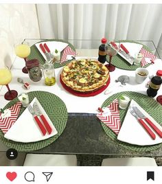 the table is set with pizza and drinks