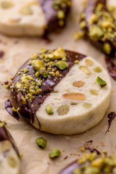 some kind of desert with chocolate and pistachio toppings on it's side