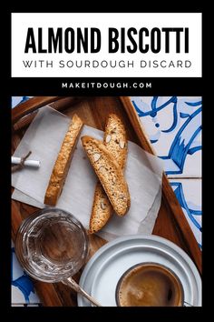 almond biscotti with sourdough disard on a tray next to a cup of coffee