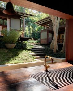 a wooden table sitting in front of a window next to a forest filled with trees