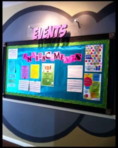 a bulletin board is hanging on the wall in front of a sign that says events