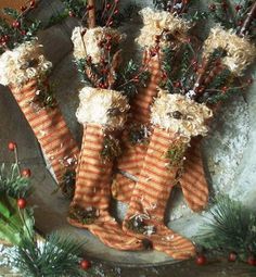 some stockings are sitting on a platter with pine branches and berries around them,