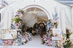 a white tent with flowers and pictures on it