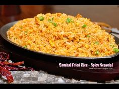 a bowl filled with rice and vegetables on top of a table