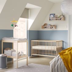 a baby's room with blue and white walls