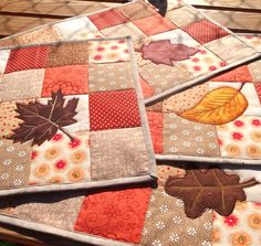 quilted autumn leaves are arranged on top of each other