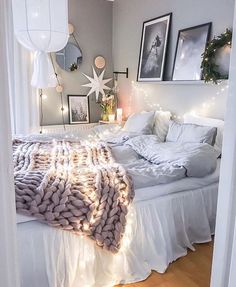 a bedroom with lights and blankets on the bed