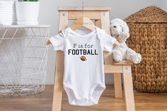 F is for Football Baby Onesie® 🏈HOW TO ORDER -Choose your size and style from the drop down menus (available sizes and styles are listed in the photos) -Add listing to your cart -Double check your address and make sure it is correct when going through checkout ✨IMPORTANT ONESIE® INFO I use Gerber onesies®, which can run small. I would suggest sizing up for your little to have more room. If the size and style you order is out of stock, I will do my best to fill your order using a different brand White Cotton Sports Bodysuit, Sporty White Cotton Bodysuit, White Cotton Sporty Bodysuit, Sporty Onesie With Letter Print For Sports, White Sports Onesie With Letter Print, White Sporty Onesie For Sports, Football Onesie, Football Baby Shower, Sports Baby Shower