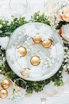 the table is set with white and gold decorations