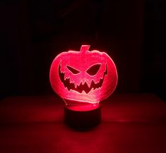 a lighted pumpkin sitting on top of a table