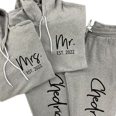 three matching mr and mrs sweatpants with drawstrings on the bottom, one in grey