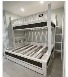 a white bunk bed sitting in the middle of a room