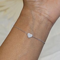 Our Dainty Silver Heart Bracelet features a delicate heart charm encrusted with CZ crystals.  This minimalist bracelet makes a great statement piece and will look great worn alone or stacked with our other bracelets. We make our jewellery in small batches to reduce wastage. Our jewellery is designed with the modern Woman in mind, elegant, unique pieces with a classic touch. Our jewellery is great for gifting, whether it's Valentines, Mothers Day, Birthday or simply a gift for a friend, sister et Wedding Heart Bracelet With Cubic Zirconia For Valentine's Day, Silver Diamond Heart Bracelet As Gift, Valentine's Day Heart Charm Bracelet With Cubic Zirconia, Valentine's Day Heart Charm Bracelet In Cubic Zirconia, Heart-shaped Cubic Zirconia Wedding Bracelets, Adjustable Heart-shaped Cubic Zirconia Bracelet, Adjustable Cubic Zirconia Heart Bracelet, Silver Diamond Bracelet For Valentine's Day Wedding, Valentine's Day Bracelets With Heart Charm And Cubic Zirconia