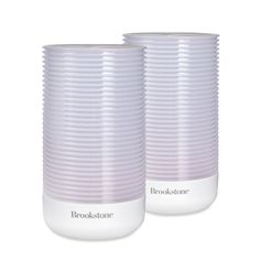 two white vases sitting next to each other on a white surface with the words brookstone