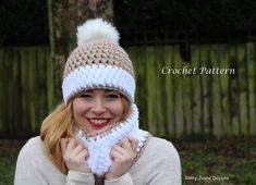 a woman wearing a crochet hat and scarf with a white pom - pom