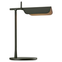 a black desk lamp with a brown shade on it's side and a white background