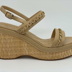 These Lambskin Leather Sandals Feature A Goldtone Interwoven Chain Embellished Straps And Raffia 3.25" Wedge Heel With 1" Platform. White Cc Logo At The Back Of The Heel. Goldtone Chanel Signature Embossed Buckle. Leather Insole. Leather Sole. Made In Italy. Designer Color: Beige. Size: 41.5 Eu (Insole Measures 10.5"). Typically Chanel Shoes Run Small. Brand New In The Box. Luxury Sandals With Chain Strap For Spring, Luxury Beige Wedge Sandals For Summer, Luxury Chain Strap Sandals For Spring, Luxury Spring Heels With Chain Strap, Luxury Heels With Chain Strap For Spring, Luxury Chain Strap Heels For Spring, Luxury Synthetic Wedge Sandals For Summer, Summer Leather Heels With Chain Strap, Luxury Sandals With Chain Strap For Summer