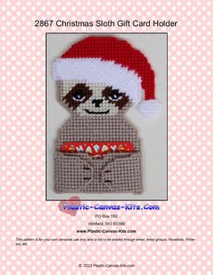 a crocheted christmas sloth card holder with a santa hat on it's head