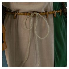 a close up of a person's belt with rope and buttons on the side