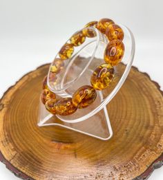 This high quality beautiful Natural Flower Amber bracelet is adjustable stretchy and made with high quality stretch cord for lasting durability. Fits most sizes. Amber meaning revolves around balancing and clearing your mind and feelings. It takes out negative energies and surrounds you with warmth. Other Amber benefits include attracting good luck, eliminating fears, and helping you develop wisdom and patience. For More Information on Natural Amber, please refer to: Amber | Meaning, Benefits, Chakra Healing, Feng Shui, Zodiac, Birthstone (soulcharmsnyc.com) Amber Meaning, Amber Benefits, Clearing Your Mind, Special Necklace, Healing Crystal Jewelry, Amber Bracelet, Clear Your Mind, Natural Amber, Chakra Healing