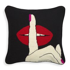 a black pillow with red lips on it and a hand making the middle finger sign