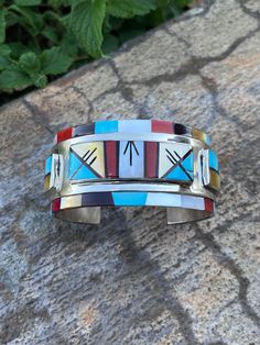 This bracelet cannot be bent at all  Width 1 1/4 6 5/8 including gap Native American Watches, Modern Multicolor Cuff Bangle Bracelet, Modern Multicolor Bangle Cuff Bracelet, Artisan Multicolor Sterling Silver Bracelets, Multicolor Artisan Sterling Silver Bracelets, Unique Sterling Silver Cuff Bracelet With Inlay, Collectible Multicolor Bangle, Southwestern Multicolor Cuff Bangle, Modern Multicolor Polished Jewelry