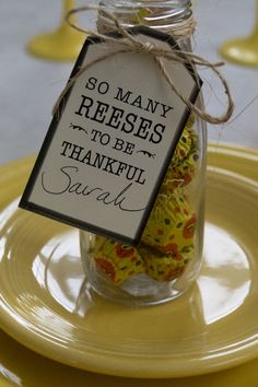 a jar filled with candy sitting on top of a yellow plate