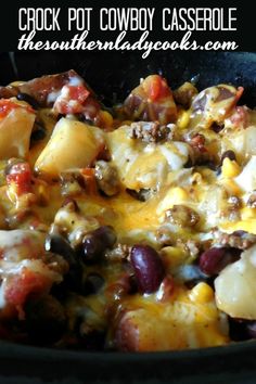 a skillet filled with potatoes, black beans and cheese