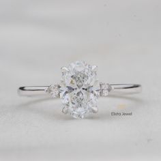 an oval cut diamond ring with three side stones