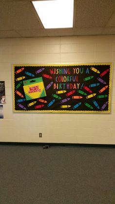 a bulletin board on the wall in a school hallway that says wishing you a colorful birthday