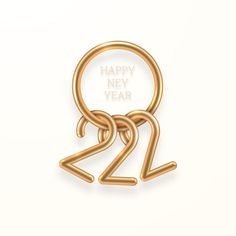 a gold metal keychain with the words happy new year on it's side