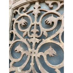 an ornate iron work on the side of a building's door, with horse heads carved into it