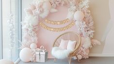 a room decorated with pink and white balloons, garlands, and pom poms