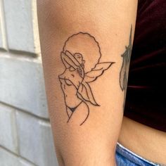 a woman's arm with a tattoo on it that has a flower in the center