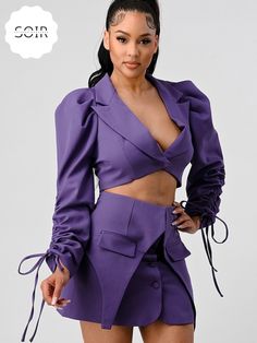 Introducing our Regal Orchid Fringe Elegance Set – a captivating ensemble that effortlessly combines modern sophistication with playful flair. This stunning two-piece set features a striking cropped blazer and a coordinating skirt, both adorned in a regal shade of purple. The blazer takes center stage with a deep V-cut, adding a touch of allure to the ensemble. The cuffs of the blazer are adorned with fringes, providing a unique and customizable element to your look. These fringes can be tied in Blazer Skirt Set, Black Jumpsuit Dress, Black Cutout Dress, Blazer And Skirt Set, Denim Crossbody, Purple Long Sleeve, Purple Skirt, Blazer And Skirt, Classic Blazer