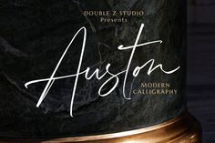 a black marble lamp with the word houston written on it's side and gold trimming