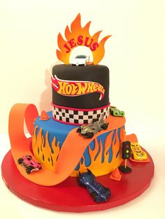 a birthday cake with cars and flames on it