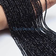 black seed beads on a woman's arm, close up shot with focus on the beading