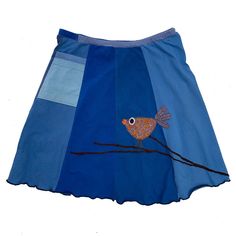 a blue skirt with a bird painted on it's side and two different colors