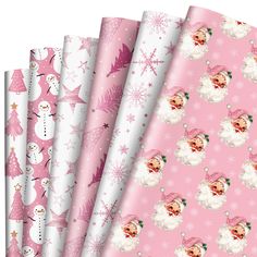 pink and white christmas wrapping paper with snowmen, bears, and trees on them