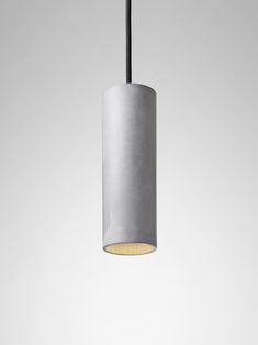 a light that is hanging from the ceiling in front of a white wall and floor