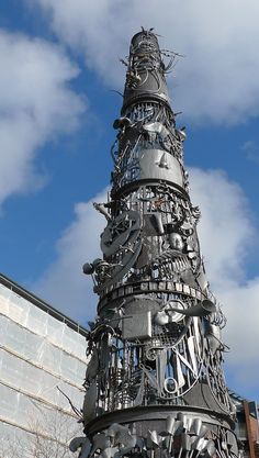 a very large metal christmas tree in front of a building