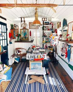 a living room filled with lots of furniture and pictures on the wall next to it